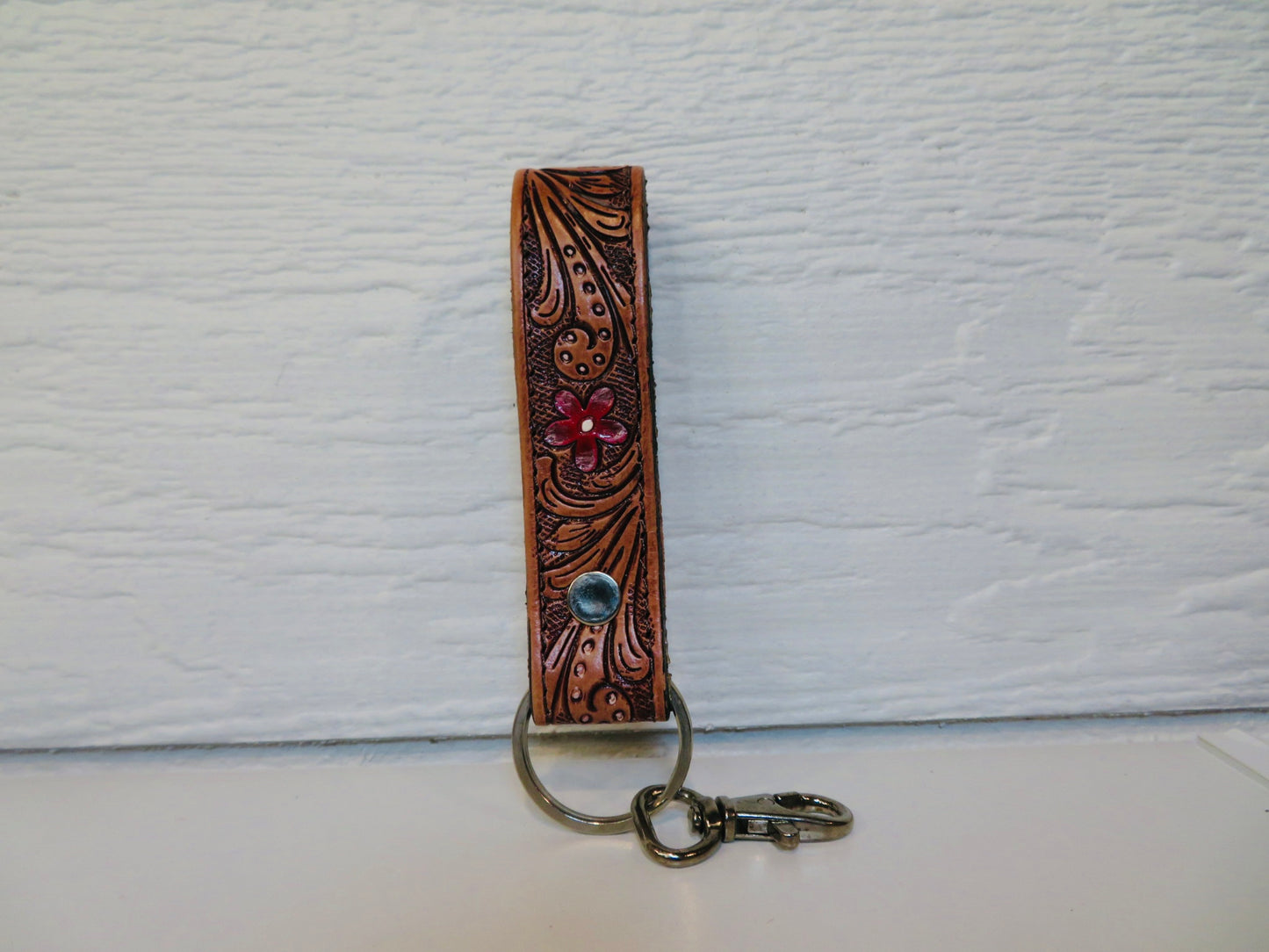 Tooled leather with painted red flowers